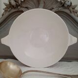 Mismatched old soup plates accompanied by a soup tureen
