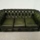 Three-seater green leather Chesterfield sofa