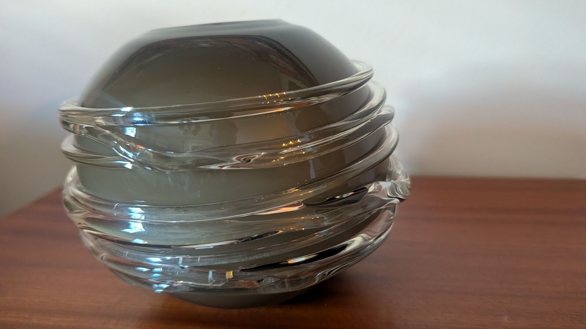 Smoky glass spherical vase with spiral applications from the 1970s.