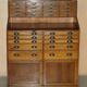 Antique English Art Deco furniture in hand-carved oak, 26 drawers.