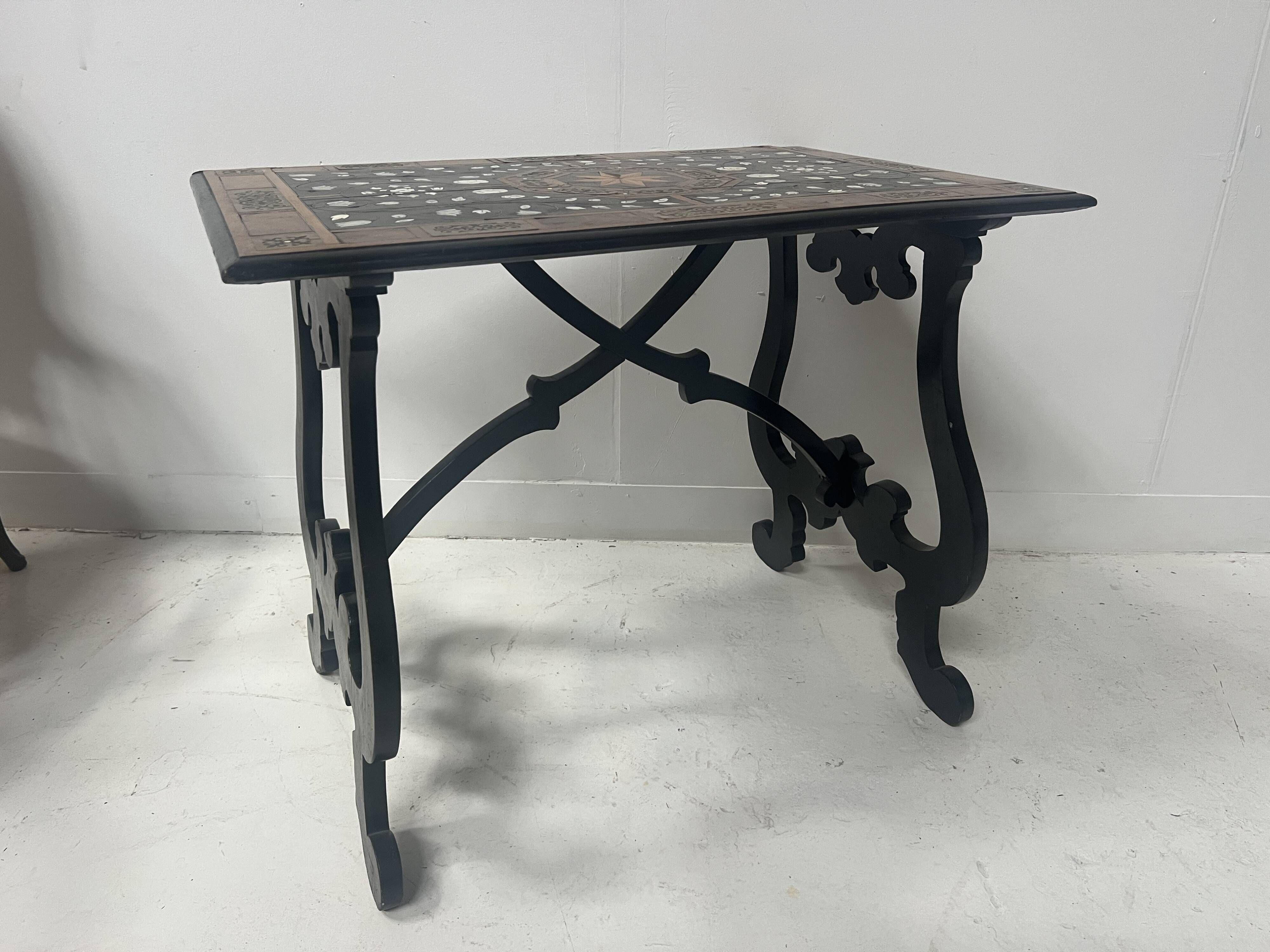 Blackened wood display table with marquetry top, Spain, 19th century.