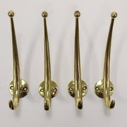 Two curved wall coat racks in brass by Franz Hagenauer, Vienna, mid-20th century, 1950s.