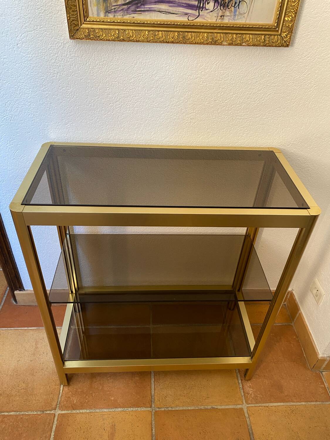 Regency style console table, in gilded metal and smoked glass