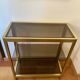 Regency style console table, in gilded metal and smoked glass
