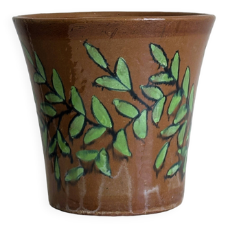 Cache-pot en céramique marron avec motif de feuillage vert peint à la main.