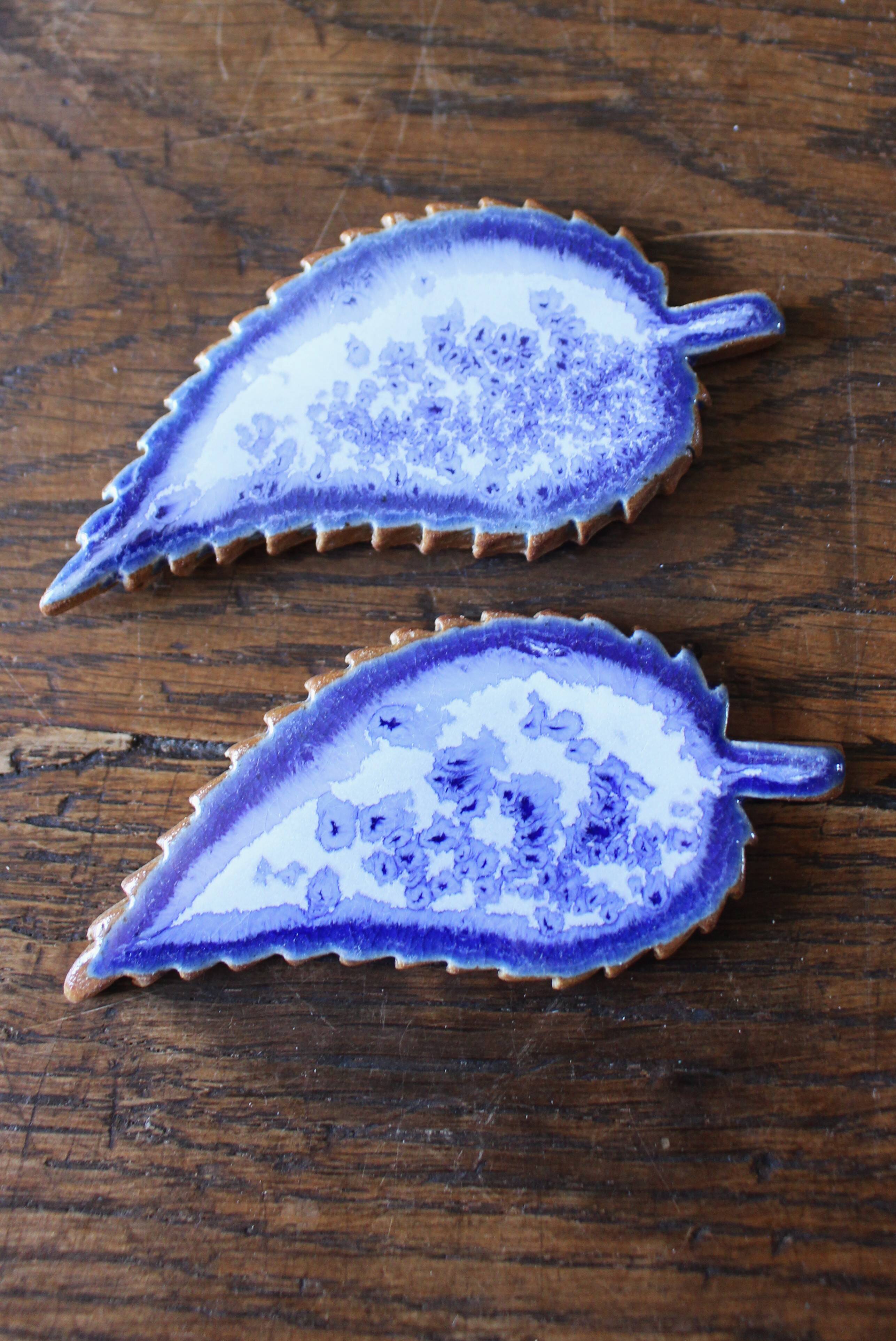 A set of 4 handcrafted pottery knife rests in blue.