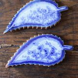 A set of 4 handcrafted pottery knife rests in blue.