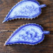 A set of 4 handcrafted pottery knife rests in blue.