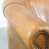 Sheep leather club chair in a cognac color with patina