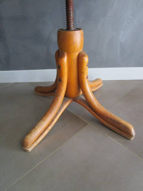 Old swivel office armchair in curved wood