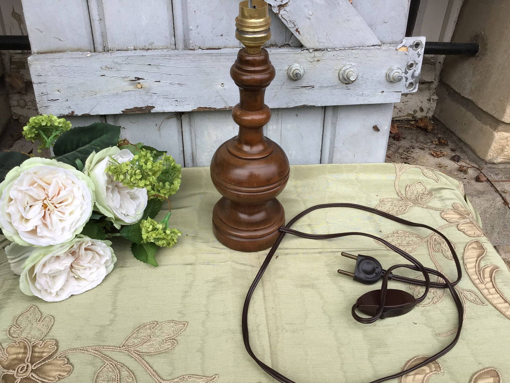 Turned wooden foot lamp with pleated lampshade