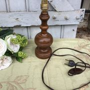 Turned wooden foot lamp with pleated lampshade