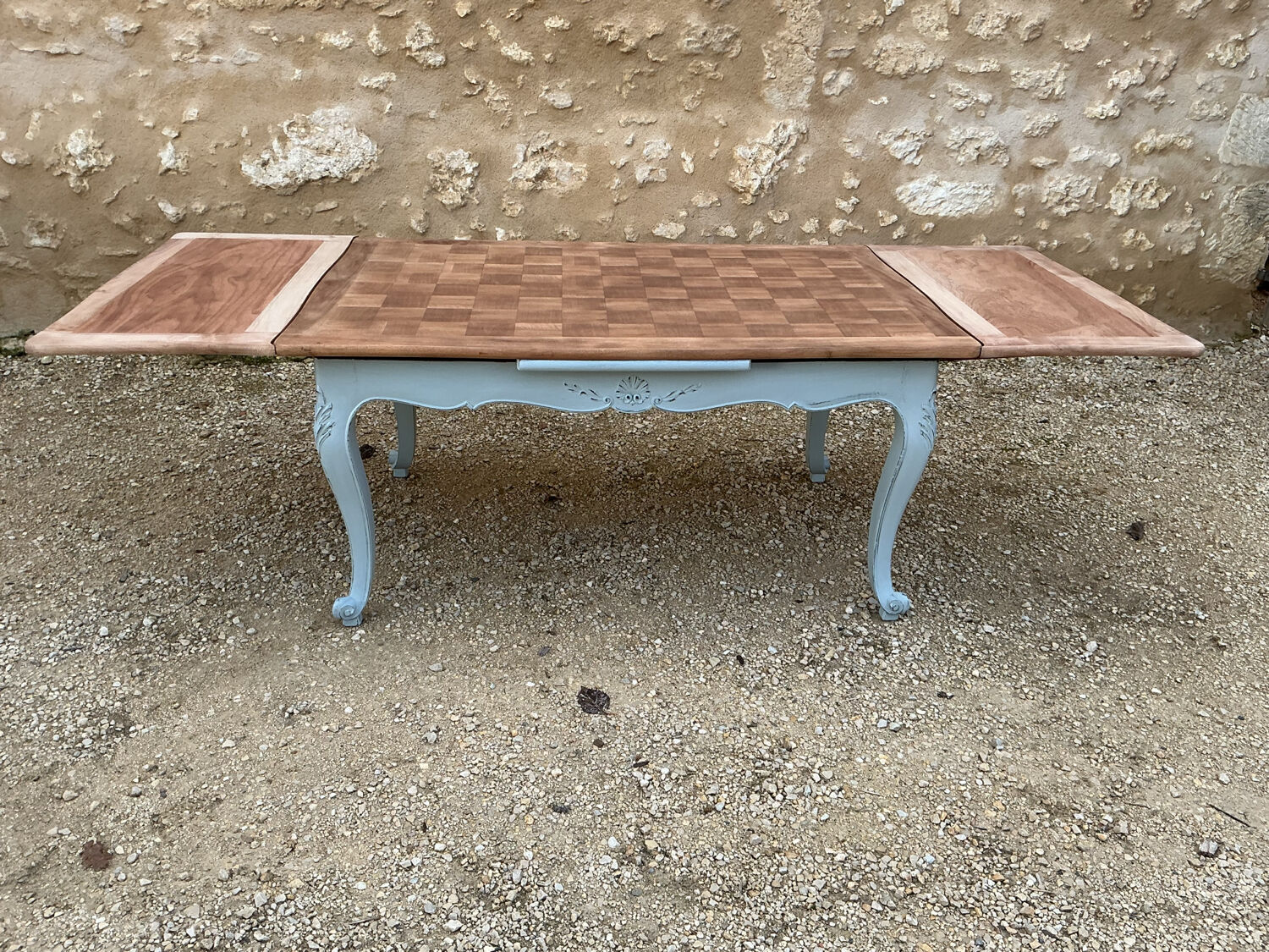 Louis XV style walnut table with a natural wood top.