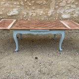 Louis XV style walnut table with a natural wood top.