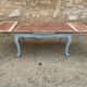Louis XV style walnut table with a natural wood top.