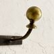 Wall-mounted coat rack with 4 hooks in metal and brass