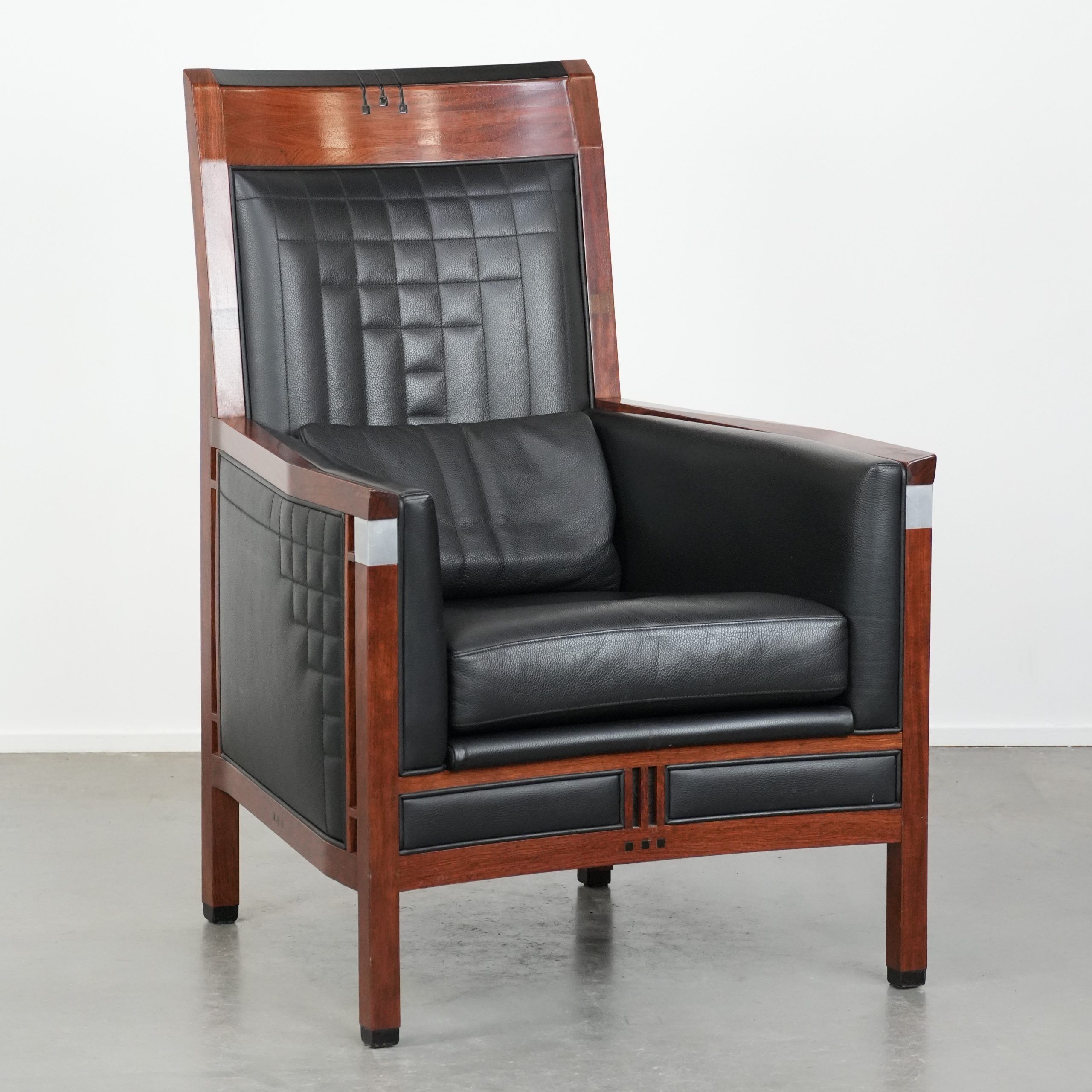 Art Deco design armchair with black leather with decorative stitching