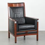 Art Deco design armchair with black leather with decorative stitching