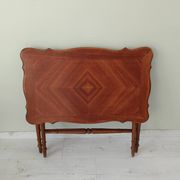 Vintage folding table with turned legs.