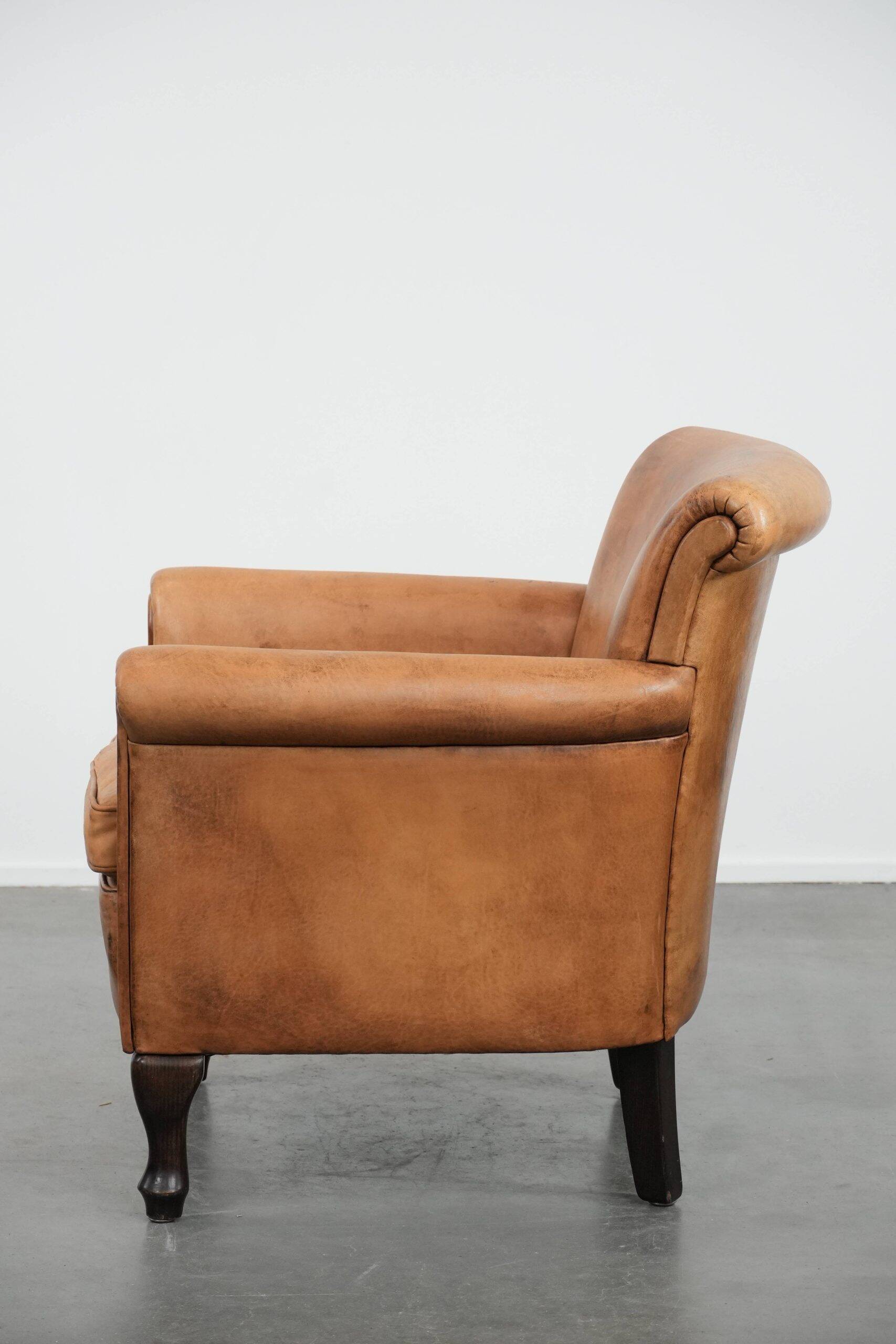 Beautiful subtle vintage sheepskin armchair with elegant legs