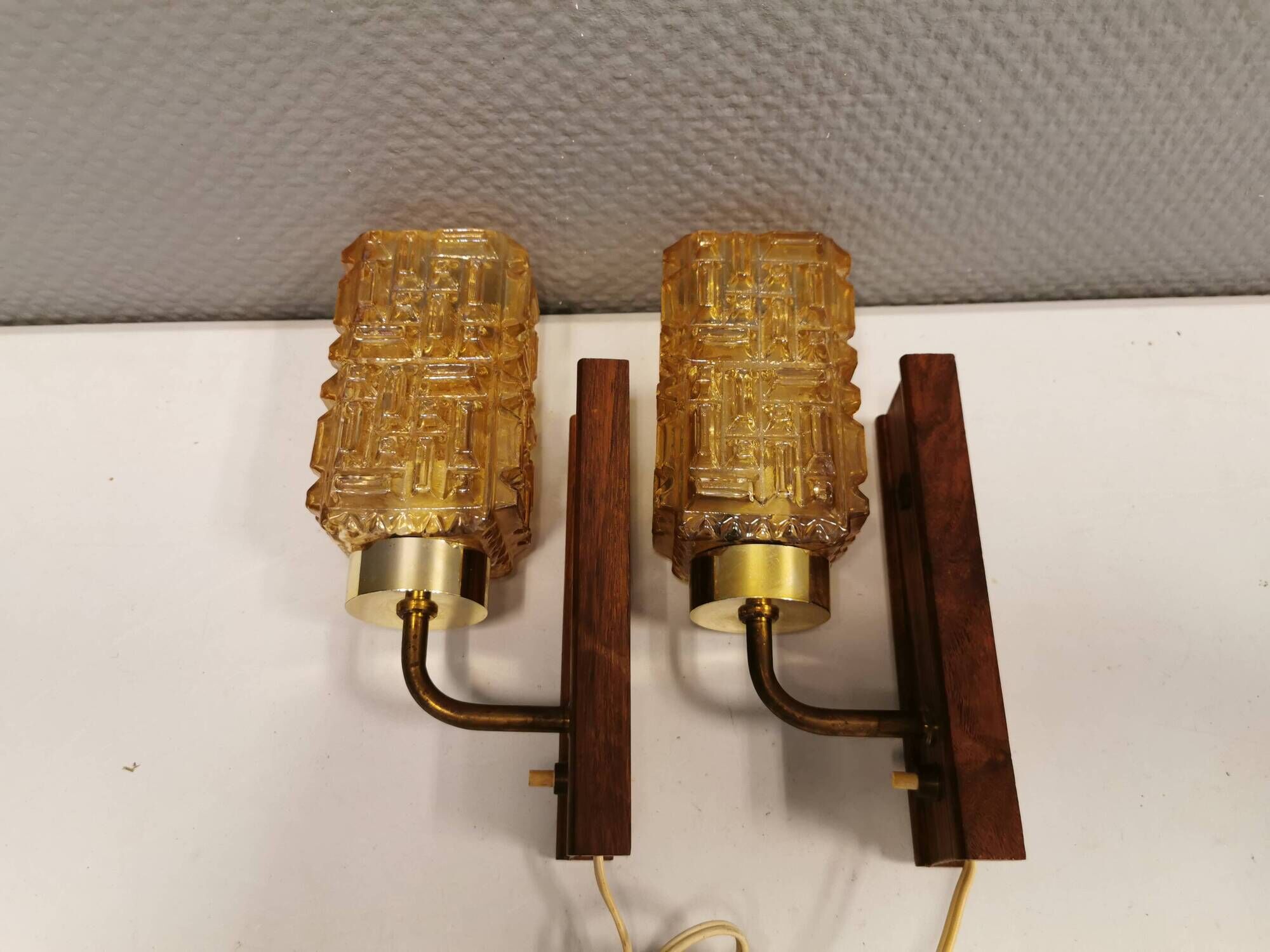wall lights in rosewood look, with amber coloured glass and brass details.
