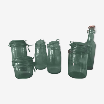 Set of 3 green colored glass jars and 1 bottle