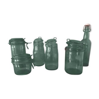 Set of 3 green colored glass jars and 1 bottle