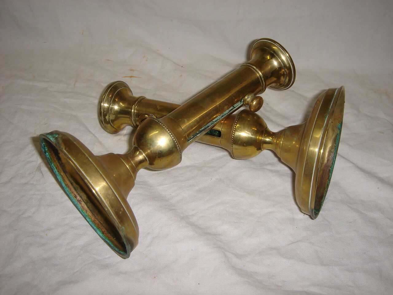 Pair of brass push-up candlesticks, 1940