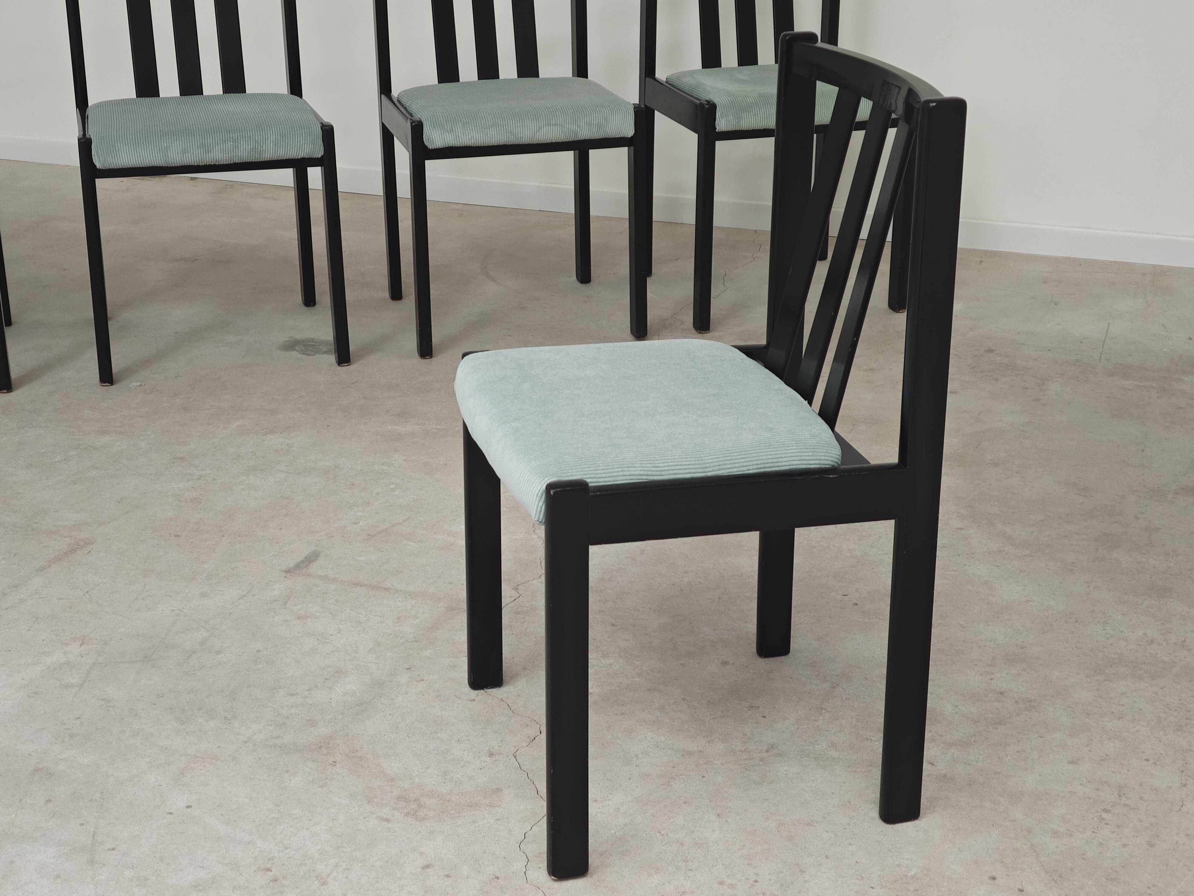 Set of 6 modernist black chairs with light blue-green ribbed fabric.