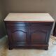 Victorian commode with a white marble top.