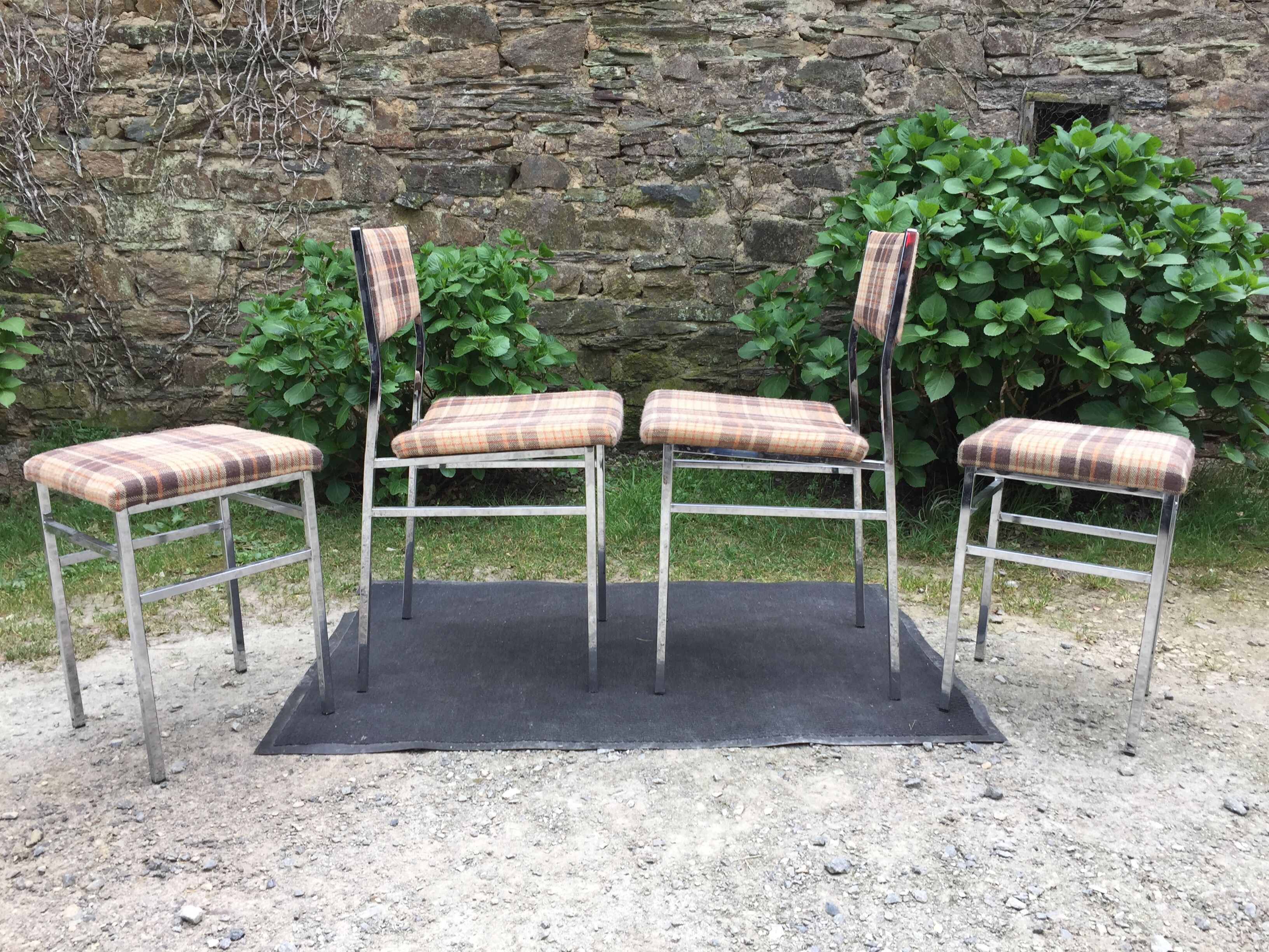 Vintage chairs and stools with chrome-plated square tubular metal base.