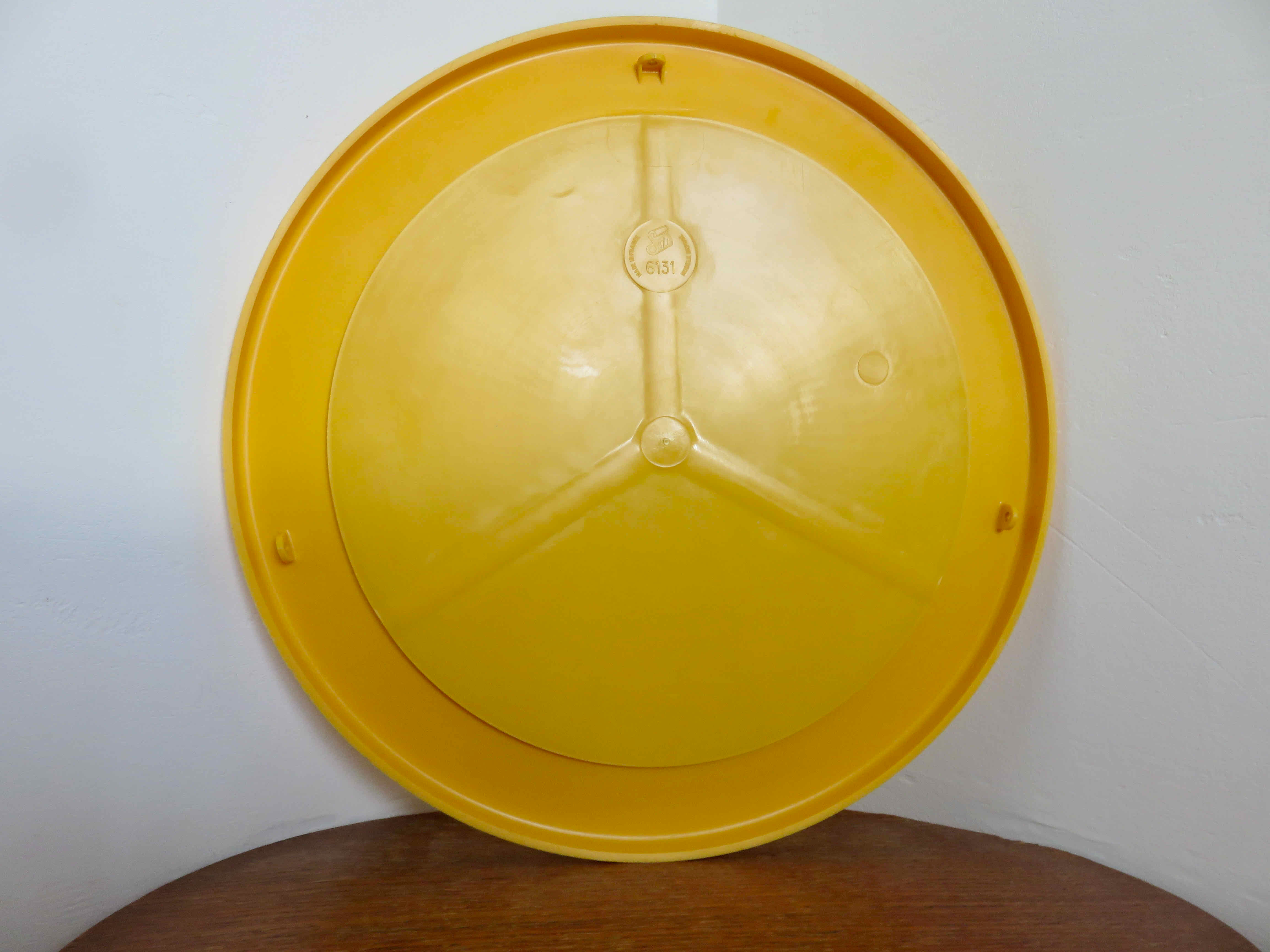 Round wall mounted mirror in yellow plastic 1970