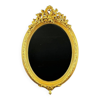 Miroir ovale doré style Louis XVI, XIXe siècle