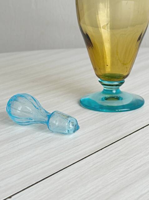 Old glass vial in yellow and blue.