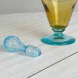 Old glass vial in yellow and blue.