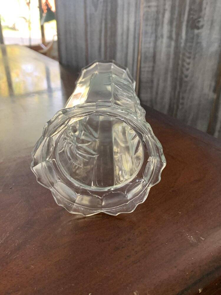 Transparent glass vase with relief floral decoration from the 1980s, fluted neck and polygonal base.