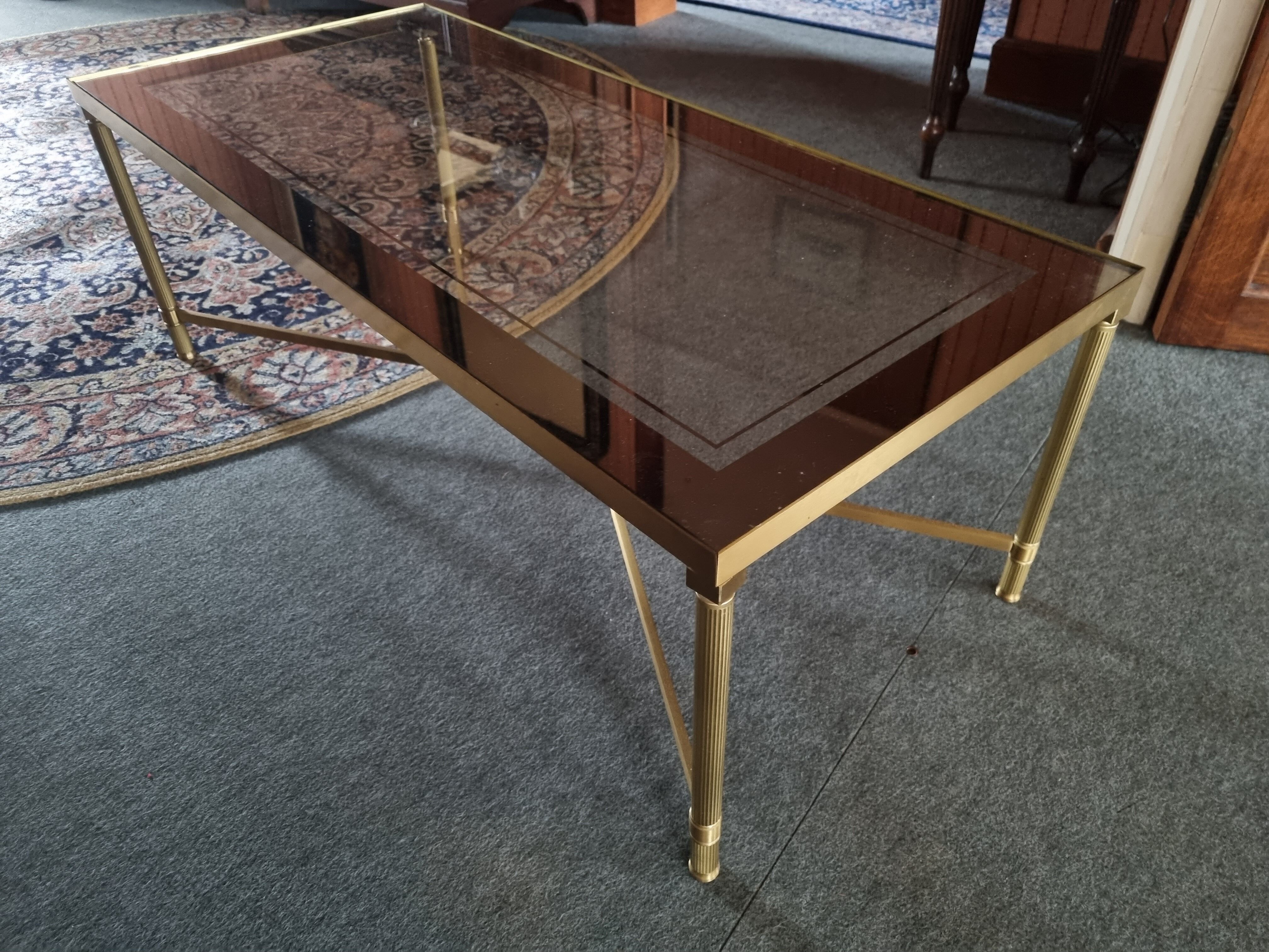 Coffee table in gilded brass and glass top