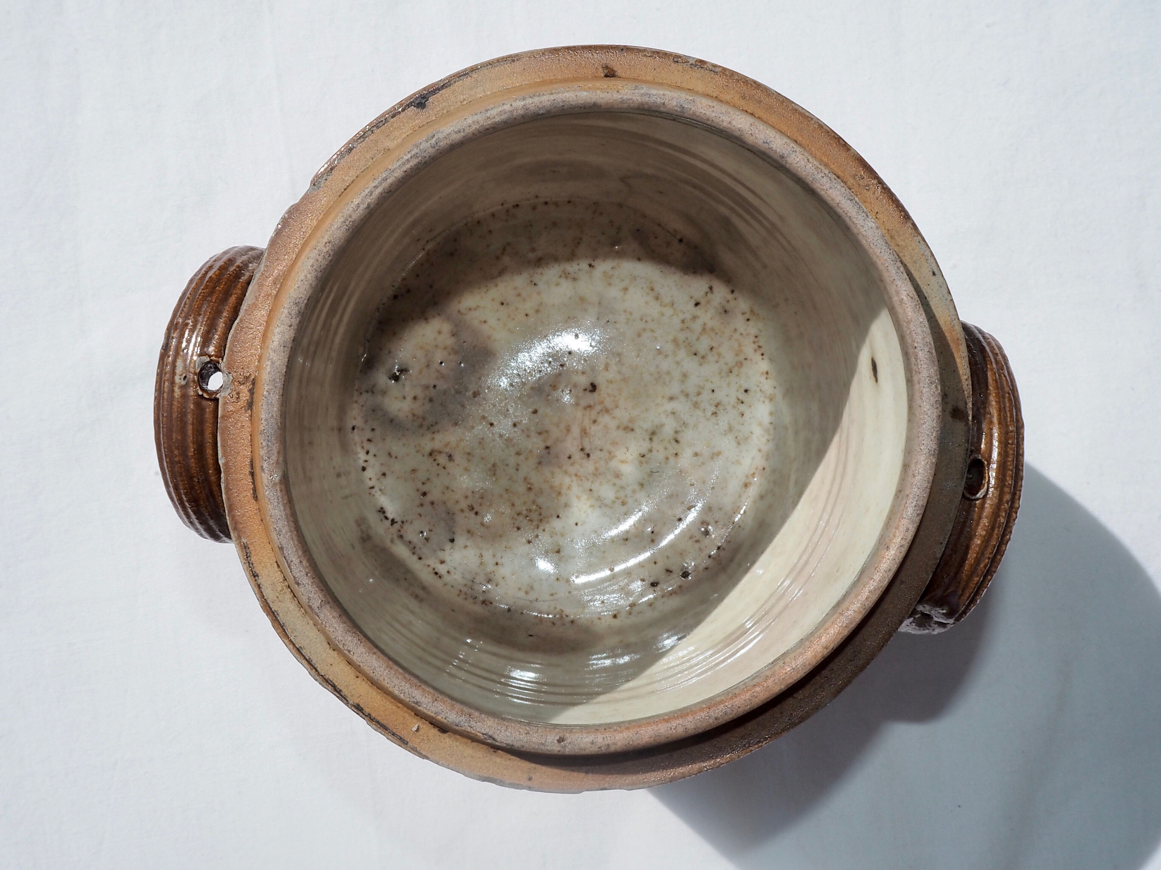 Trio of stoneware pots with lids