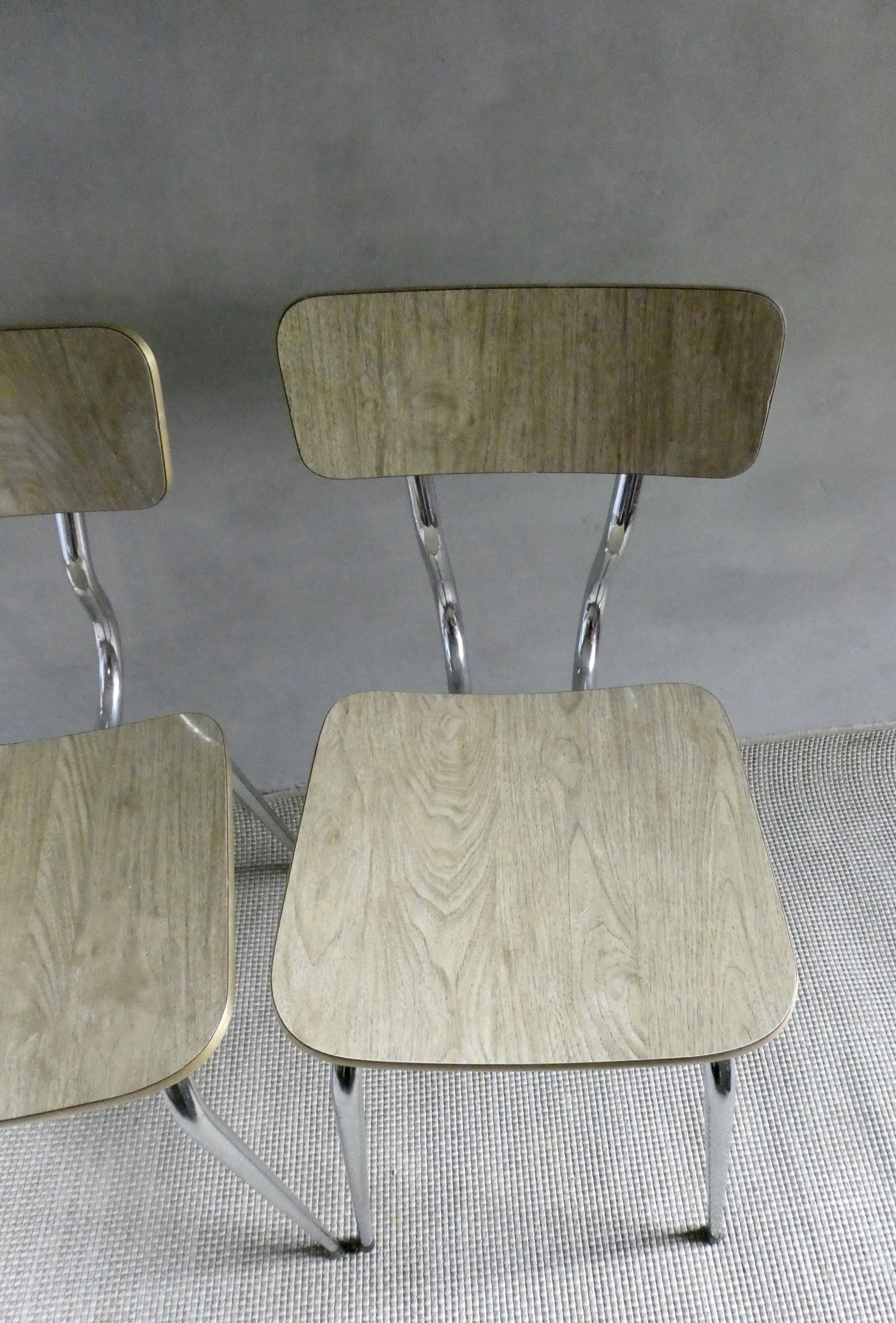 Pair of chairs in "wood" formica and gold edges, 1960s