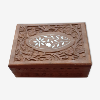 Old wooden jewelry box carved with garland of flowers