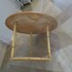 Round coffee table in bamboo, rattan, and wood with an 80s star pattern.