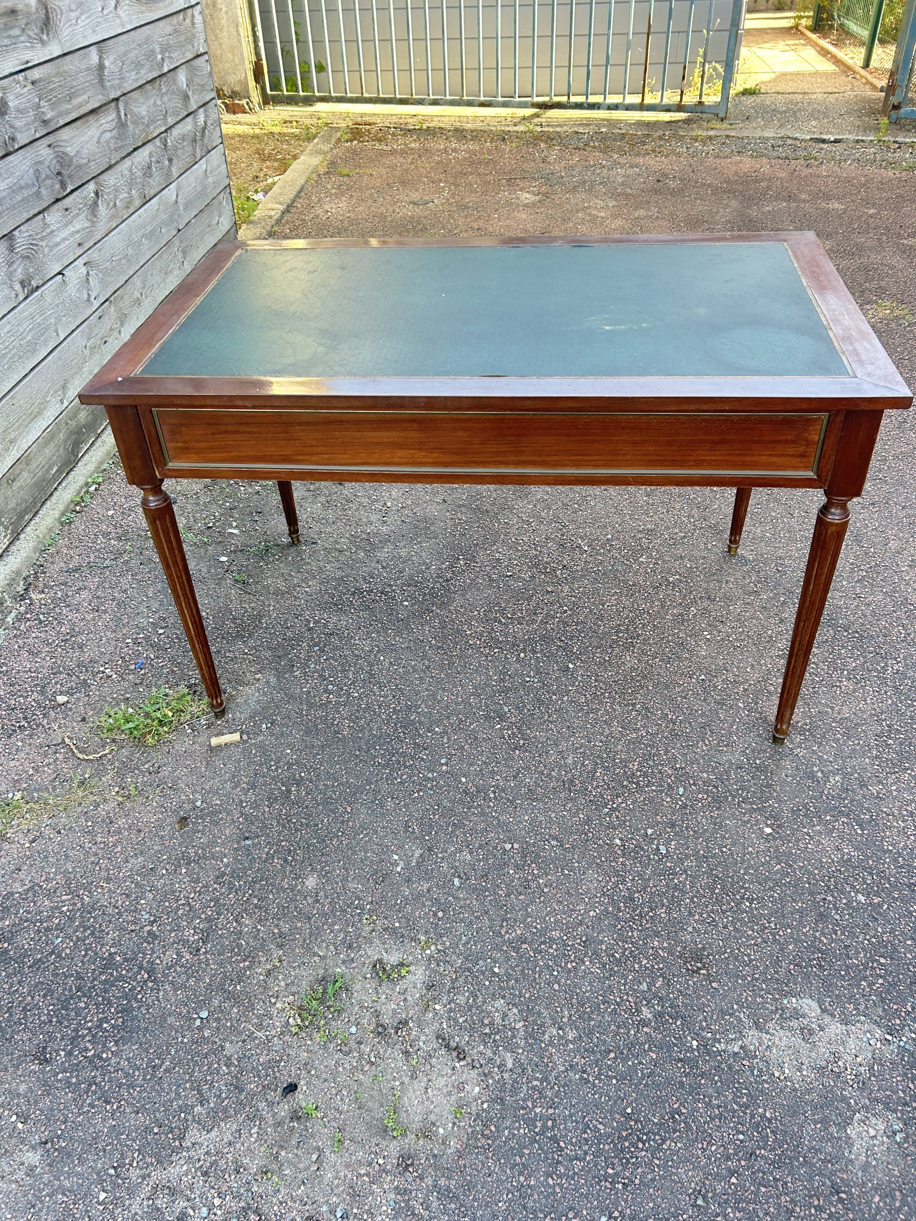 Louis XVI style desk in mahogany with a green leather top.