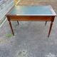 Louis XVI style desk in mahogany with a green leather top.
