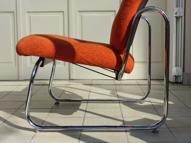The 1970s orange armchair fabric and chrome metal