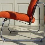 The 1970s orange armchair fabric and chrome metal