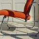 The 1970s orange armchair fabric and chrome metal