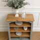 Green-grey library, wooden shelf and shelves in natural wood.
