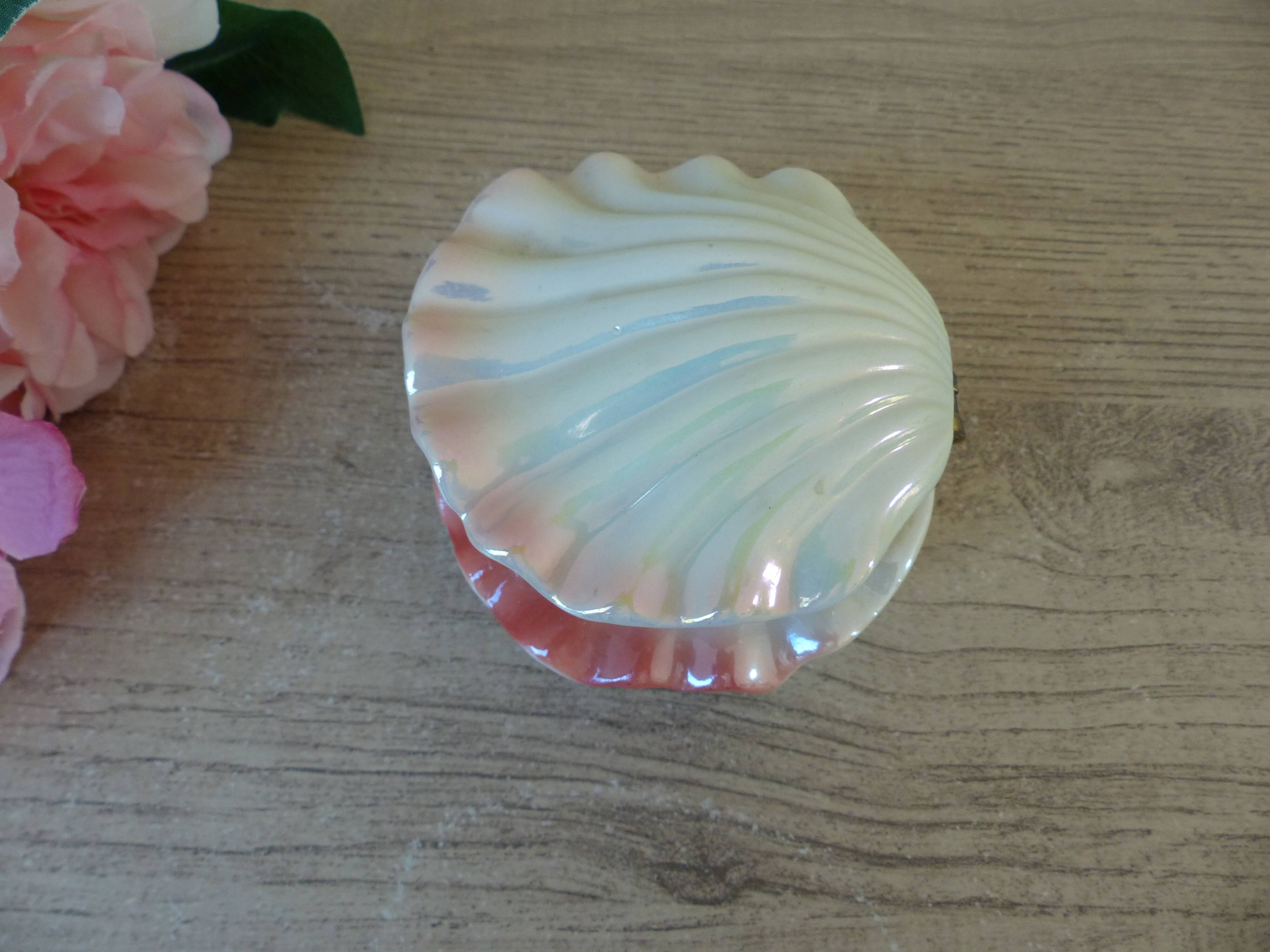 Vintage shell-shaped catchall in iridescent cream and pink ceramic.