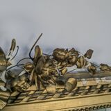 Golden Louis XVI style mirror with bouquet and shells.