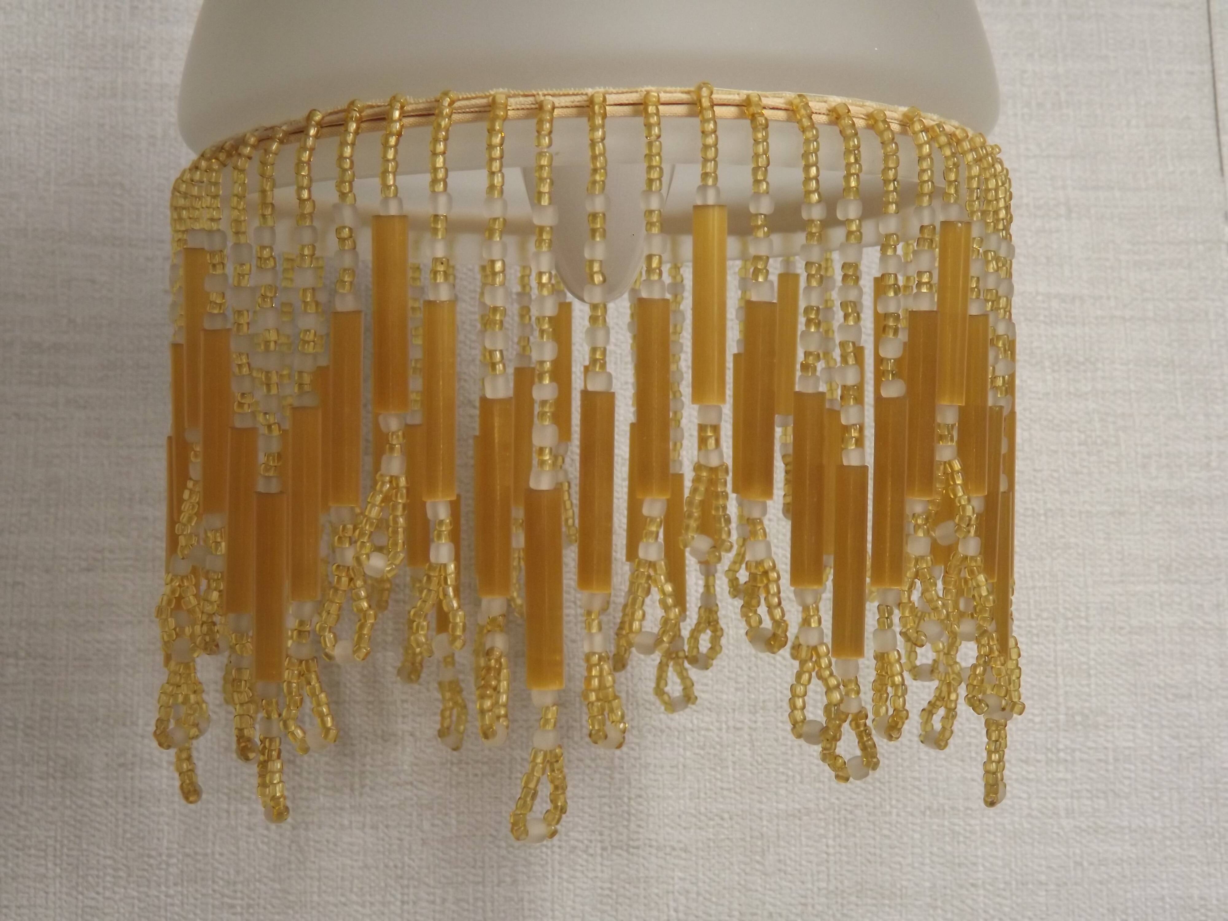 French vintage bronze effect single wall light with opaque beaded glass shade.